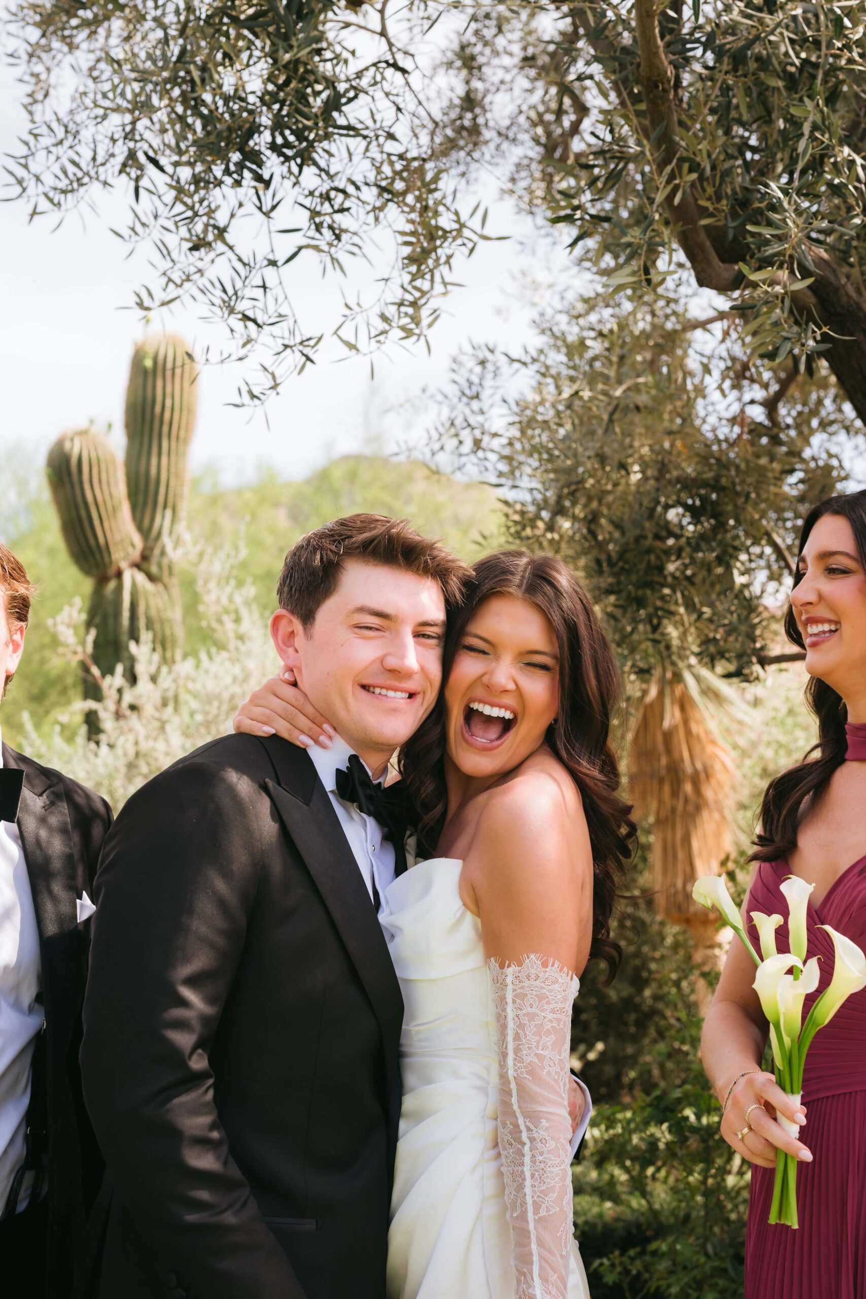 Bride and groom laughing with their wedding party during an outdoor wedding in Arizona