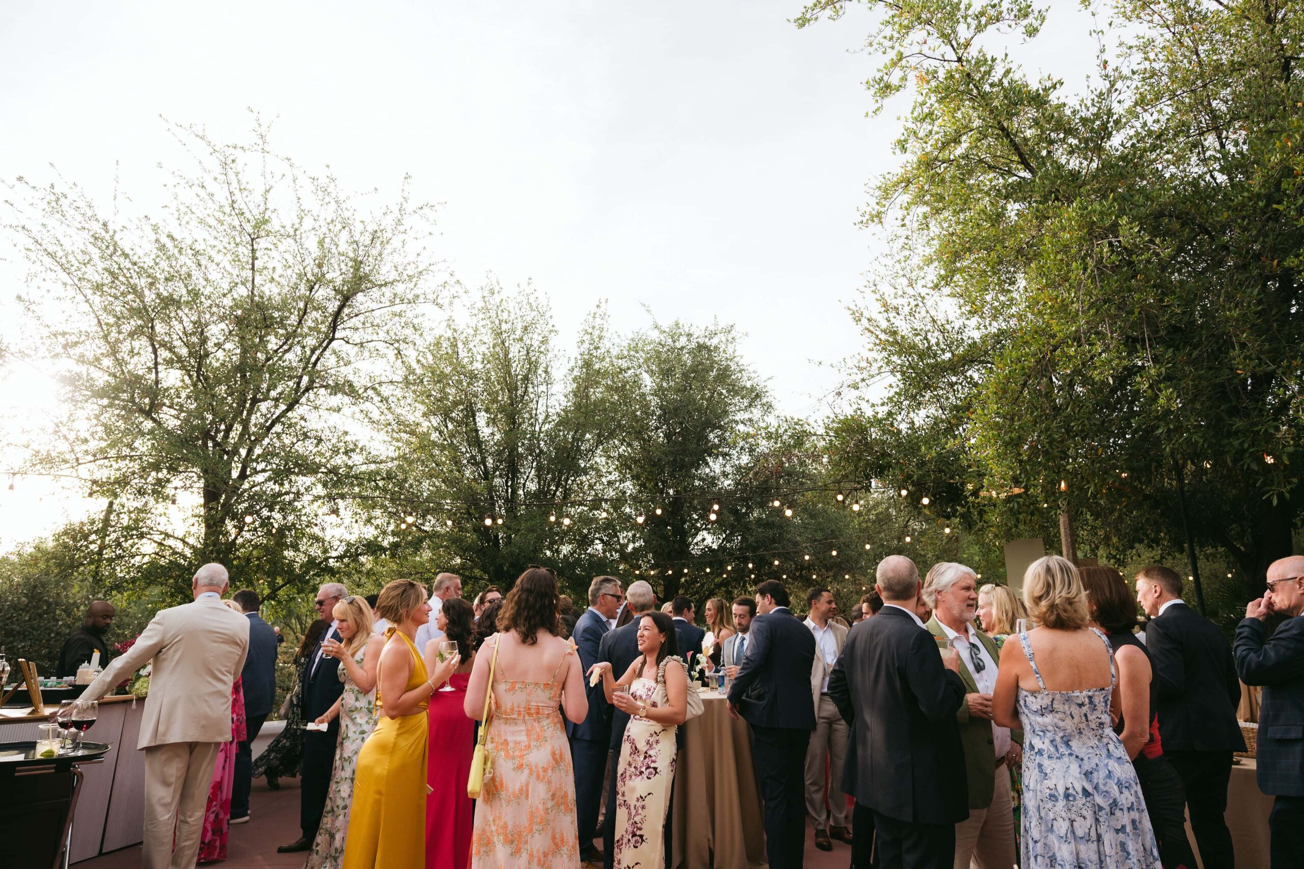 Wedding guests mingling and talking during an outdoor cocktail hour