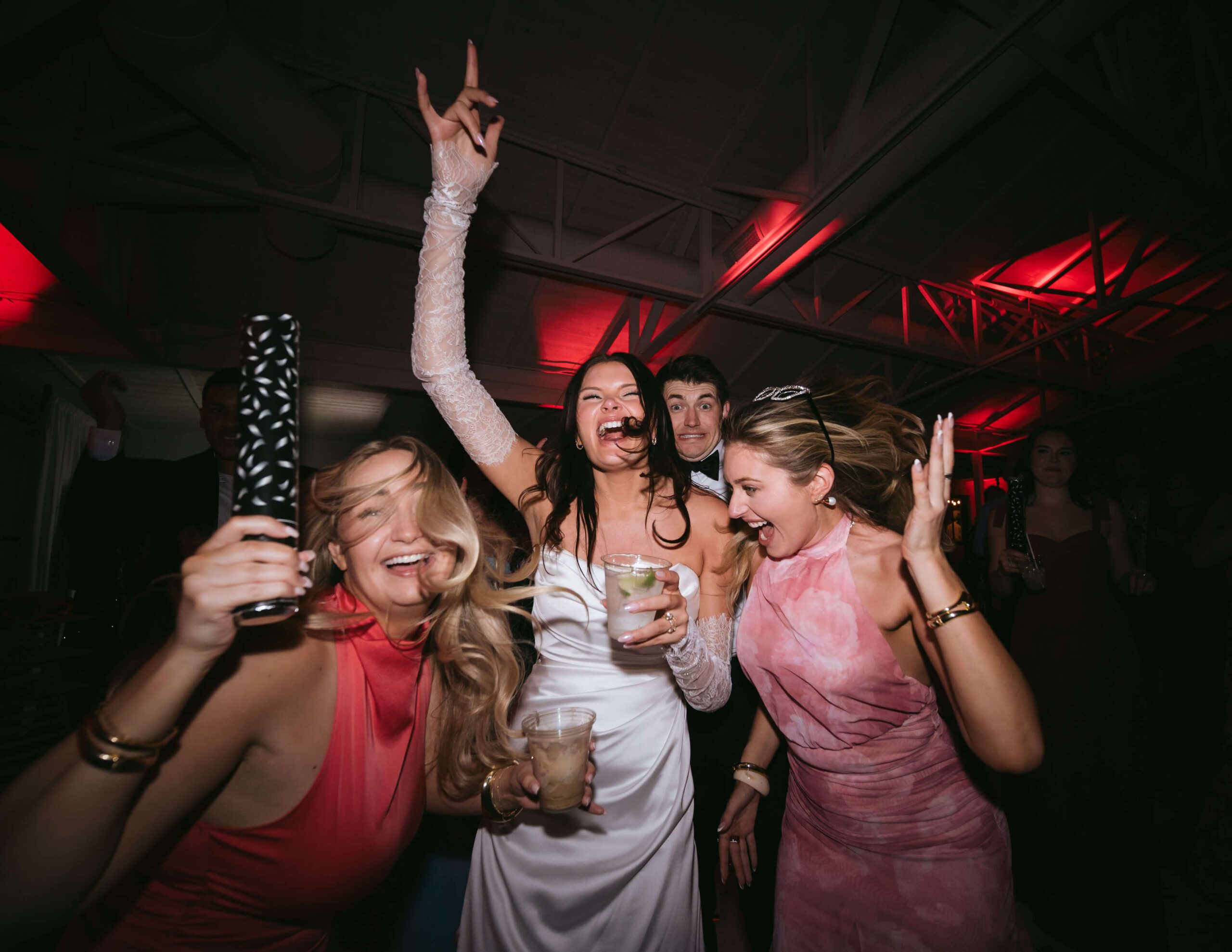 Bride and wedding guests dancing and celebrating together at a lively reception